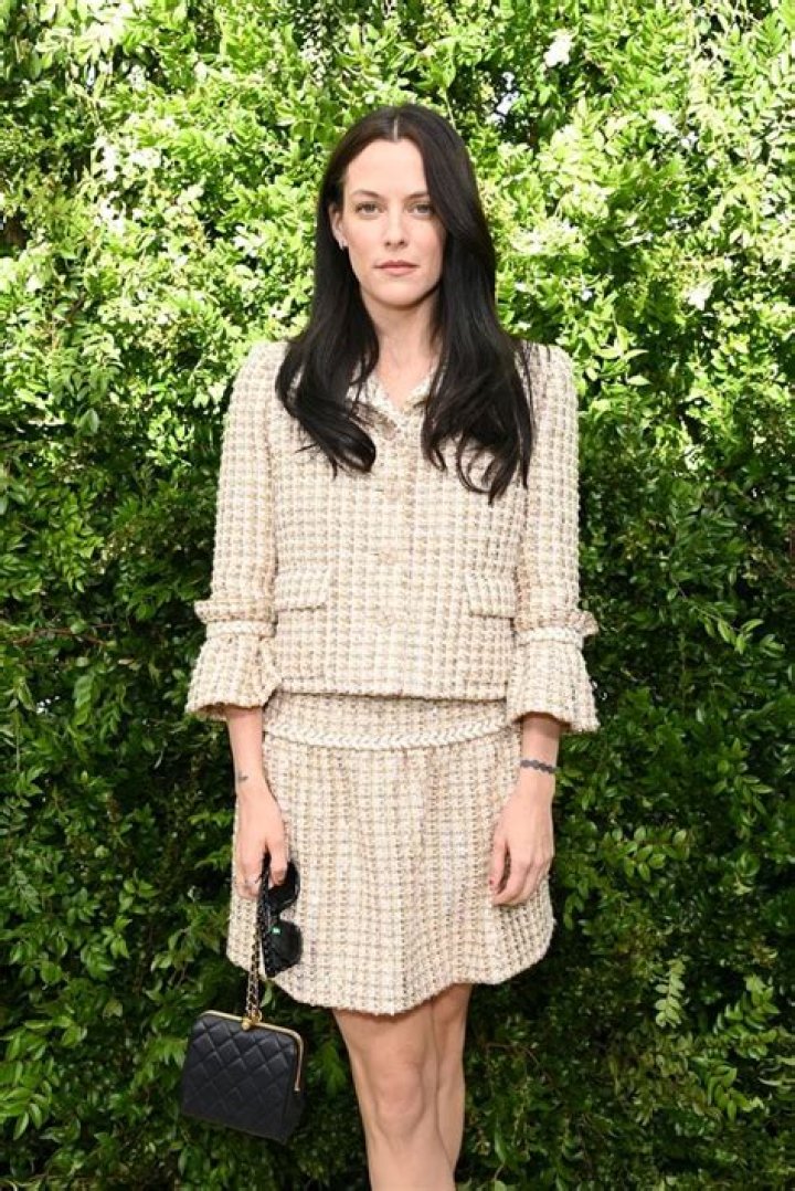 Riley Keough with dark hair in Chanel at the Globes: would be better without the overlay?