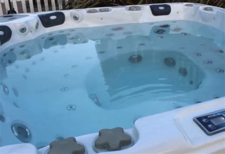What does an ozone generator do in a hot tub?